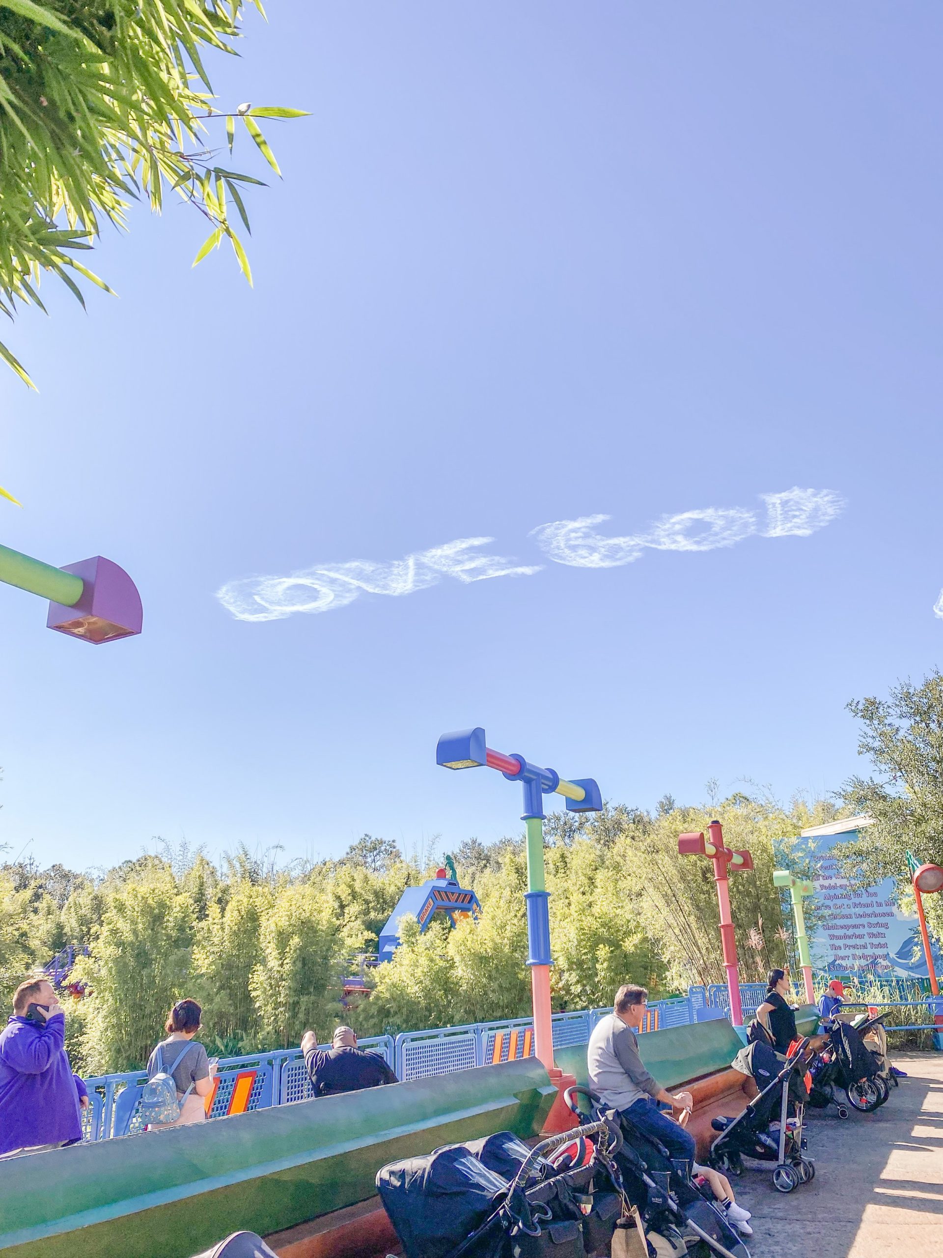  Story time: Jordan took this photo while Dottie and I were in line for Slinky Dog Dash. :  I couldn’t see it, but some people behind me could.  They were foreign and trying to figure out what was written in the sky.  They could figure out the word “